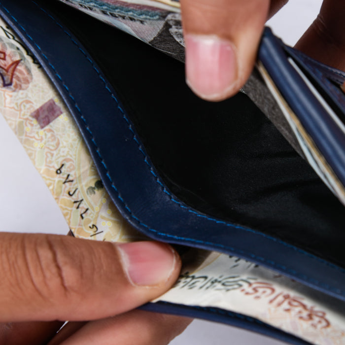 Close-up of hands holding an open blue wallet with visible currency notes