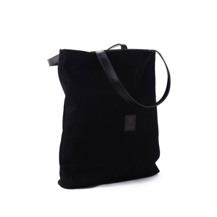Black canvas shoulder bag with leather strap and small front logo patch on white background
