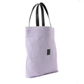 Pastel purple canvas shoulder bag with black handles, minimalist design on white background